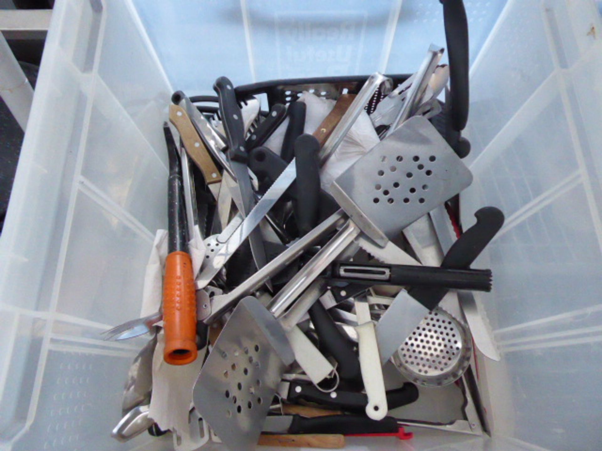 Large plastic crate with lid containing assorted chefs utensils