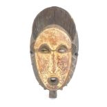 A Senufo, Ivory Coast mask of elongated form with an open mouth, h.