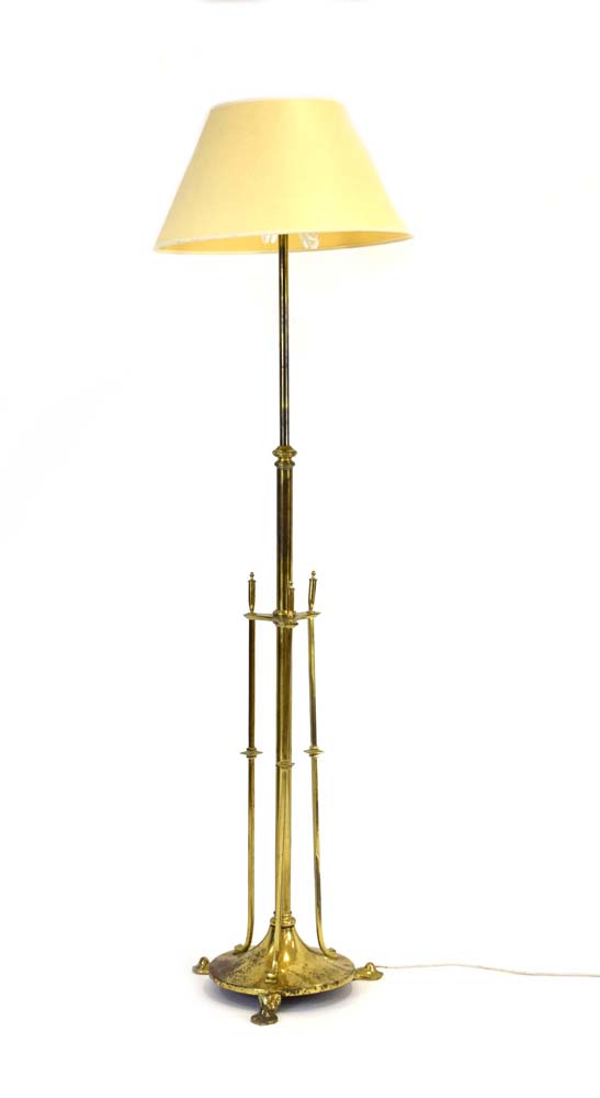 A brass standard lamp in the Arts & Crafts manner