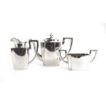 An Austrian metalware three piece tea service of canted vase shaped form, teapot h.