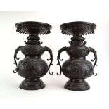 A pair of Japanese brown patinated bronze two handled vases of baluster form,