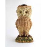 An early/mid 20th century stoneware lamp base in the form of a seated owl on an oak leaf and acorn