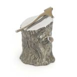 An aluminium desk piece modelled as a tree stump and axe, h.