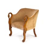 A sculptural mahogany and upholstered armchair, the arms modelled as swans,