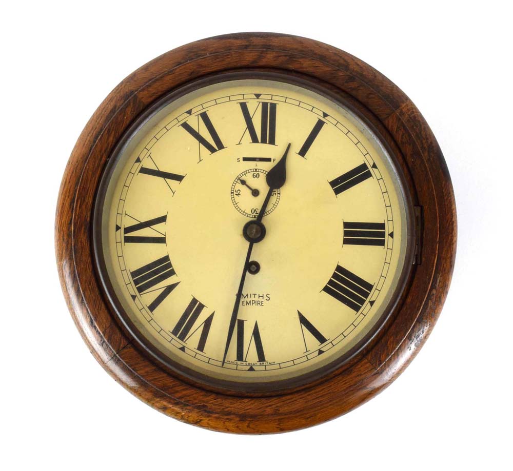 A Smiths Empire wall clock in an oak circular case, d.