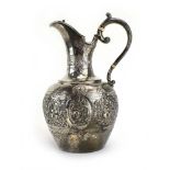 An Edwardian Scottish silver claret jug, repousse decorated in the Rococo manner, maker JR,