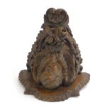 A Victorian oak wall shelf modelled as a cherub amid relief floral carvings, h.