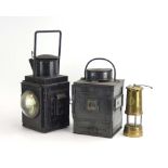 A British Rail black tole lantern together with a similar lantern and a Welsh brass miner's lamp