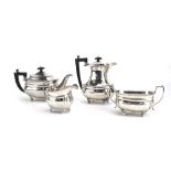 An early 20th century silver four piece tea service of vase shaped form with gadrooned decoration,