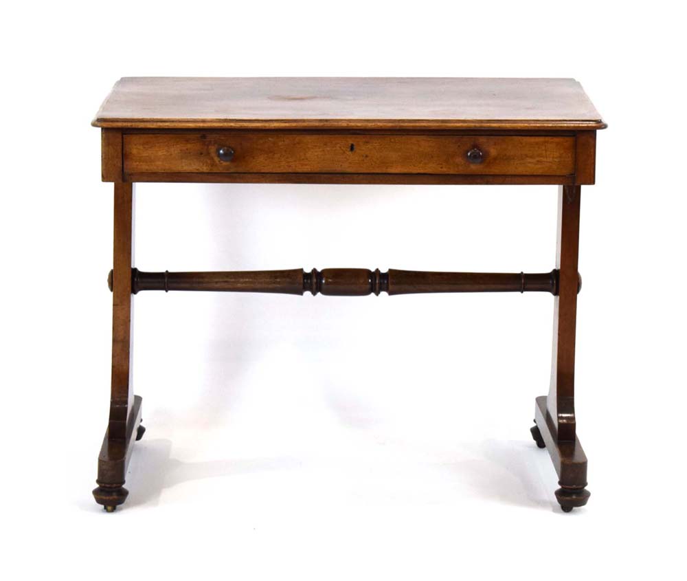 A mid-19th century mahogay writing table with a single frieze drawer on two panel supports, w.