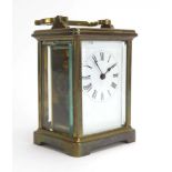 An early 20th century French carriage timepiece, the enamelled face with Roman numerals,