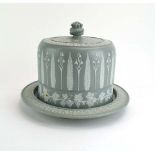 A jasperware cheese dome and cover decorated with stylised snowdrop's,