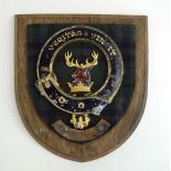 A Scottish metalwares and fabric plaque on an oak shield,