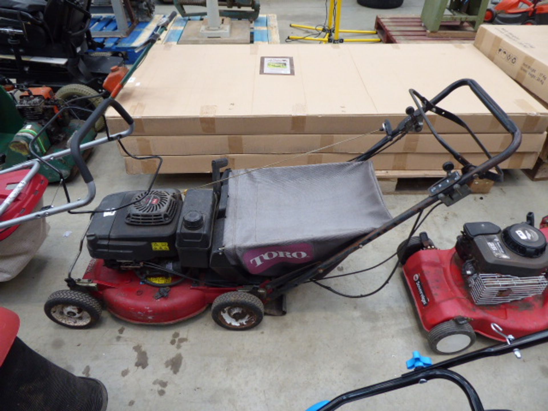 Toro red petrol powered rotary mower with grass box