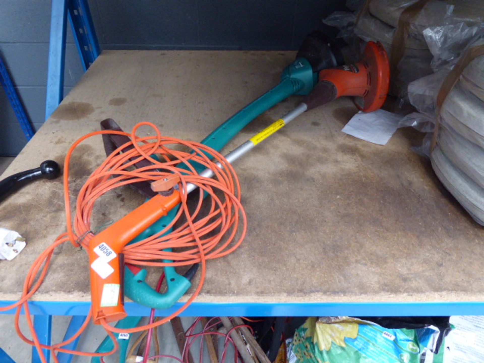 Flymo electric hedge trimmer and a Bosch electric hedge trimmer