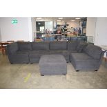 Large fabric covered L shaped sofa with large footstool