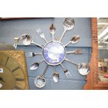 Clock surrounded by knives, forks and spoons