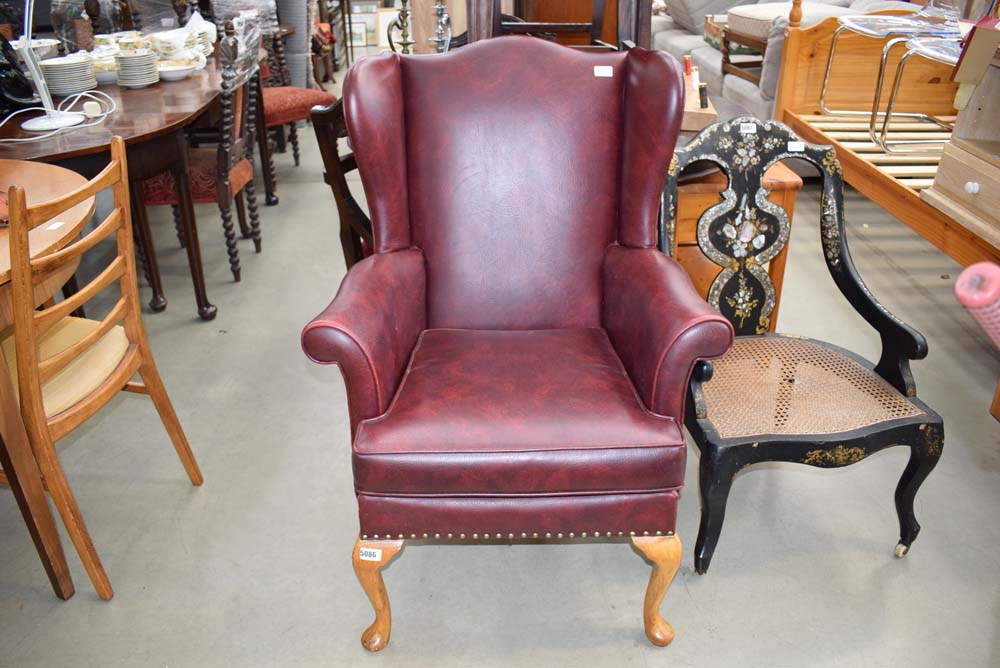 Faux red leather wingback chair by Parker Knoll