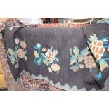 5169 - Black ground floral patterned rug