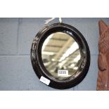 Small Victorian ebony framed oval mirror