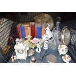 Cage of various books, glass decanters, figurines and a small mantel clock