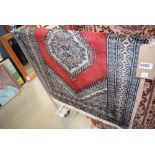 (19) Small geometric patterned rug with red centre and dark blue to black edging