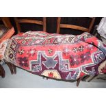 (2036RR) 156 - A mid-20th century runner decorated with a red ground and repeated motifs, 220 x