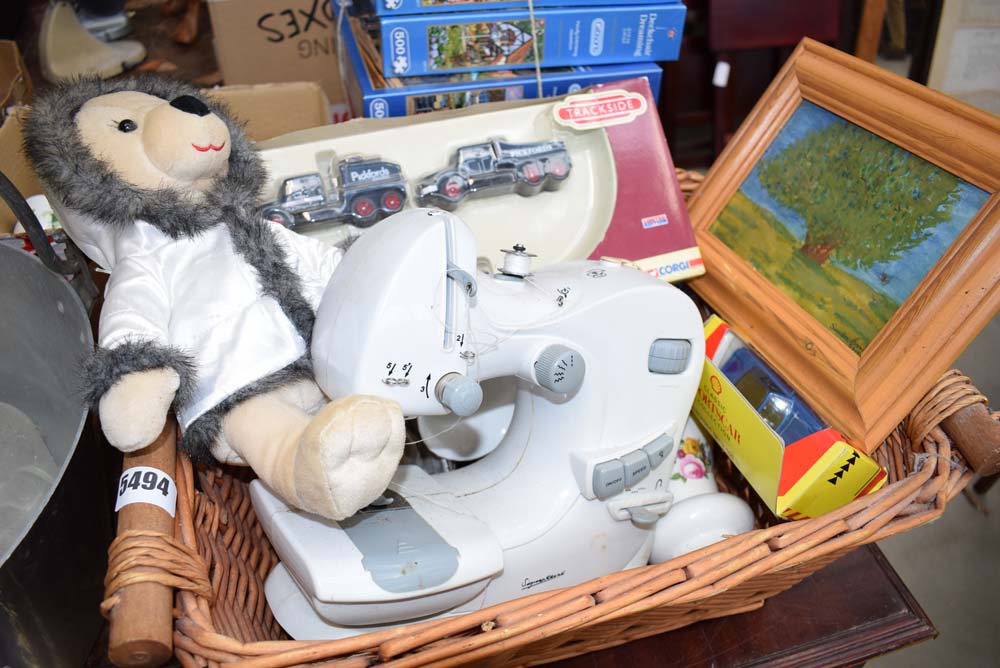 Wicker basket containing a small sewing machine, cuddly toy, framed and glazed print, Pickford's