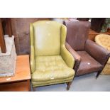 Light green leather covered button cushioned wing back chair together with a leatherette brown