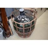 Dark green carboy in metal frame