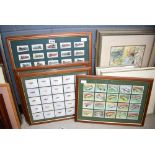 Five framed and glazed sets of cigarette cards to include fish, trains and birds