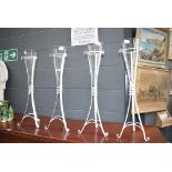 4 glass flower vases in metal stands