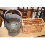 Brass coal scuttle with a wicker magazine rack