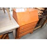 Heavily varnished bureau together with a melamine topped 1960's kitchen table and a white painted