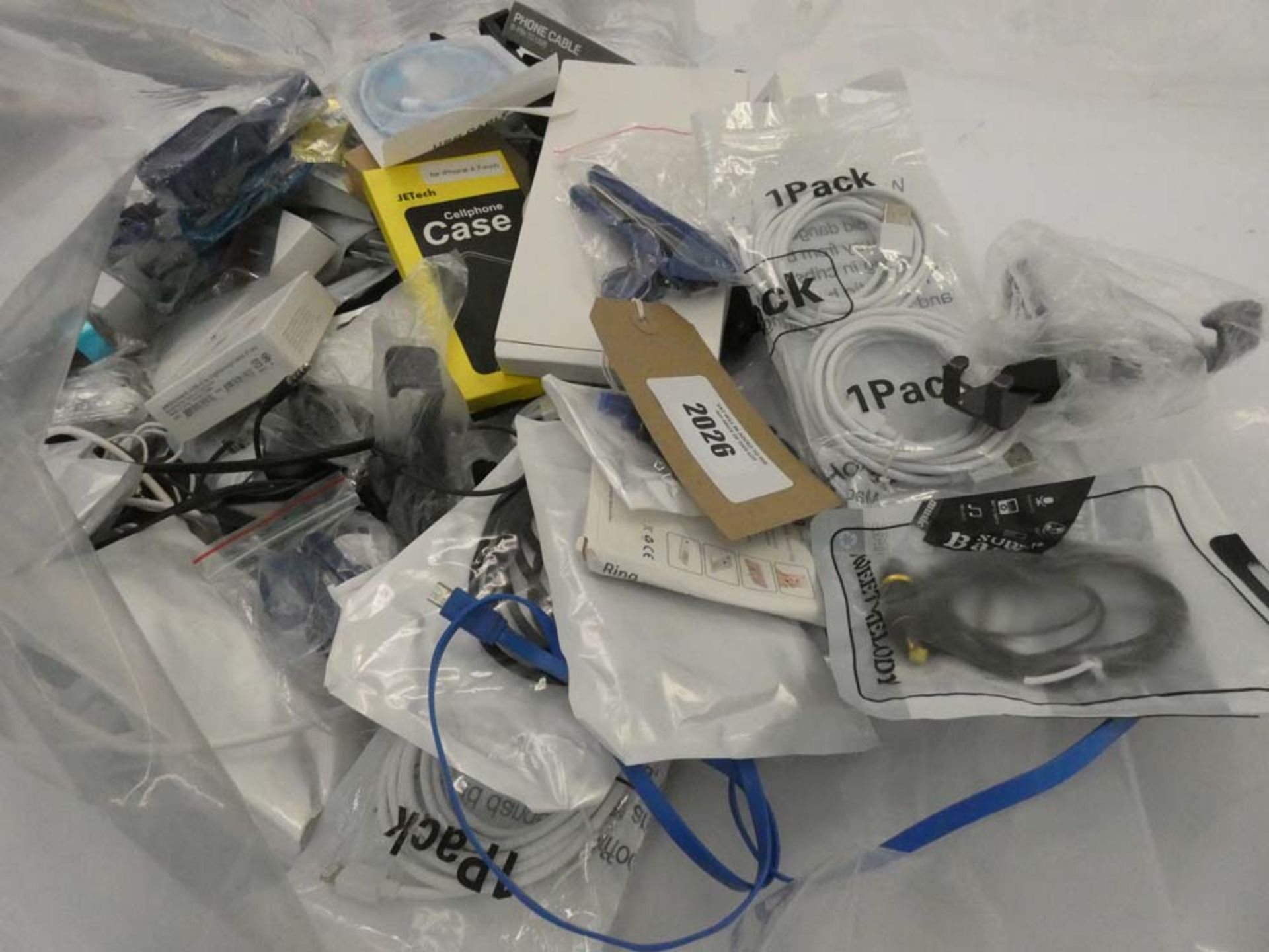 Bag containing quantity of various mobile phone accessories; leads, adapters, earphones, selfie