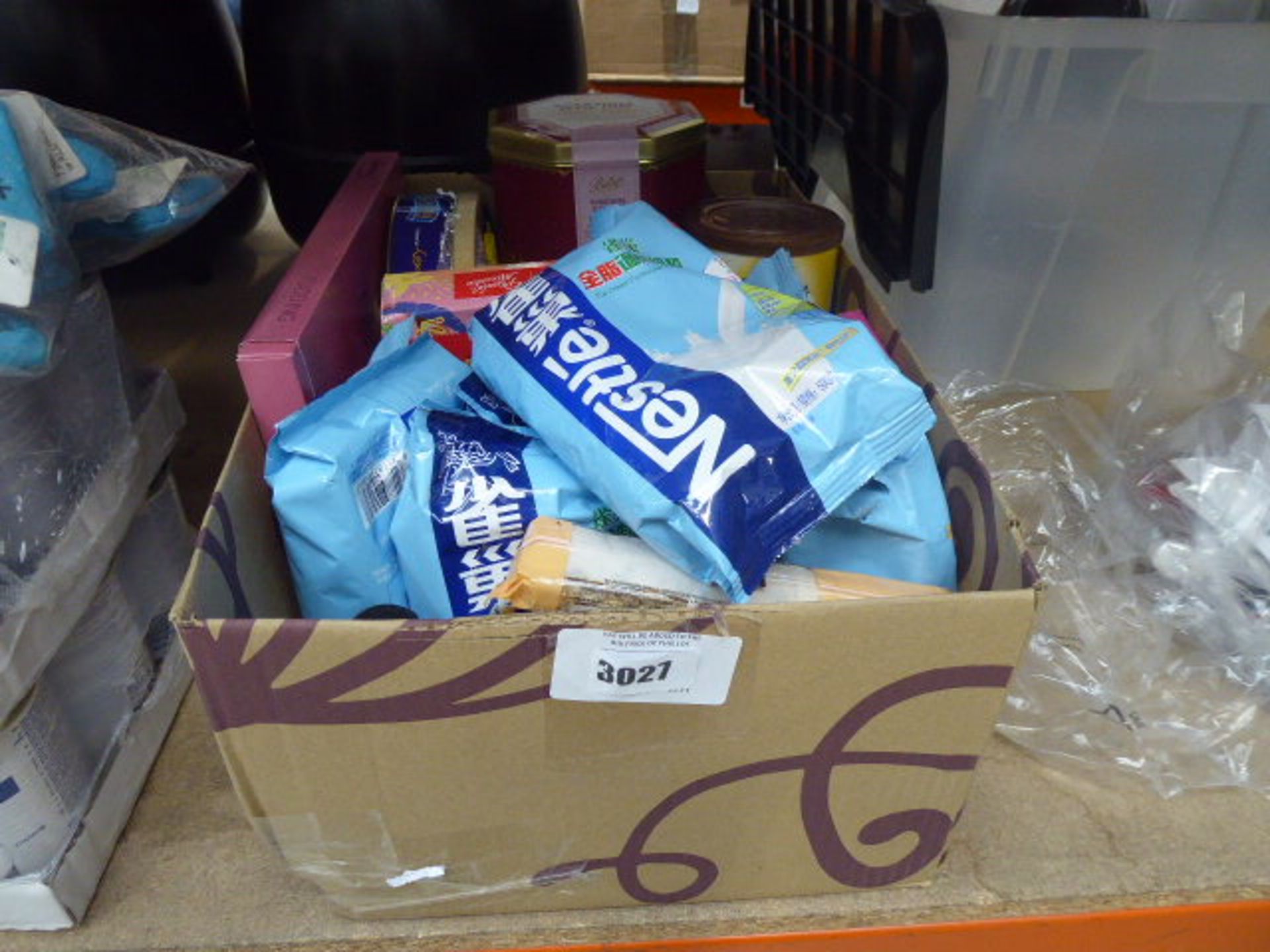 Box containing a mixture of nestle milk powder, some fruit cake, mix of assorted coffees, etc