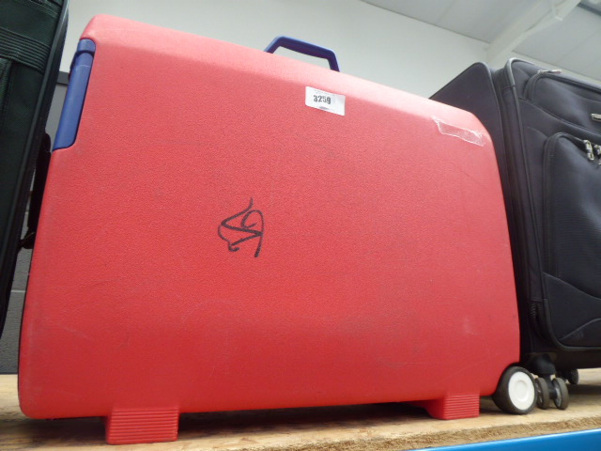 Large red hard shelled Samsonite suitcase
