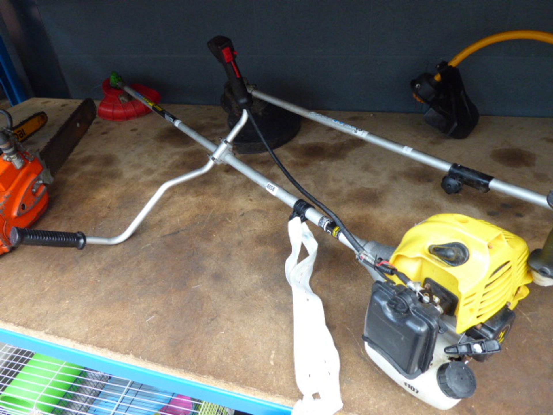 Yellow petrol powered strimmer