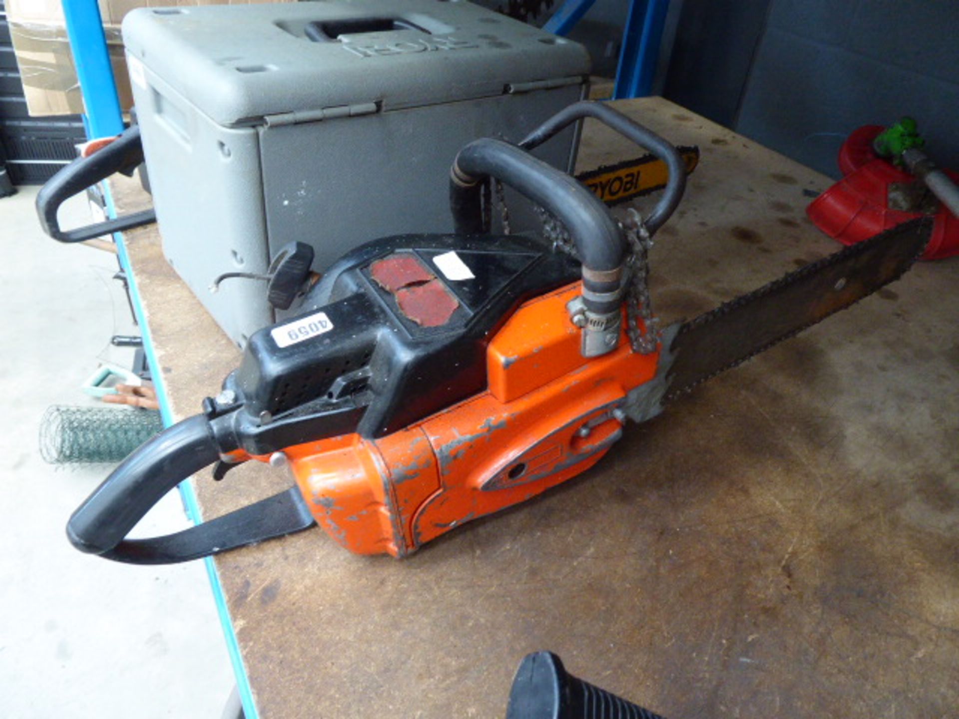 Orange petrol powered chainsaw