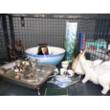 A cage containing: ornamental figures, silver plated dish, glass vase and a sea shell.