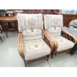 Pair of bent cane conservatory armchairs with floral decorated cushions