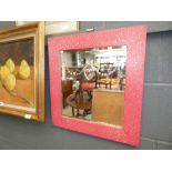 Etched mirror in red painted frame
