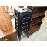 Four black painted metal stacking chairs