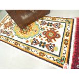 Multi-coloured woolen mat with beige background