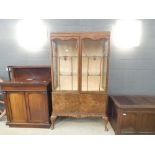 Glazed walnut double door china cabinet on cabriole supports