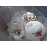 A box containing commemorative mugs and dishes