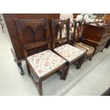 Pair of carved oak dining chairs with embroidered seats plus a stickback armchair with Bergere seat