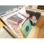 Box containing Beatles vinyl records, DVDs and reference books