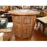 Heavily carved Indian table with folding base