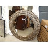 Circular mirror in decorative frame